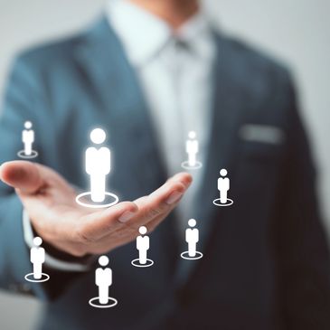 Businessman holding virtual HR icons representing team management.