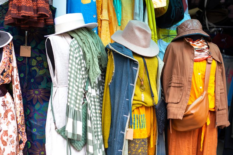 Three sets of clothes for the fall. Multi-layered clothes hanging on hangers, thoughtful imagery.