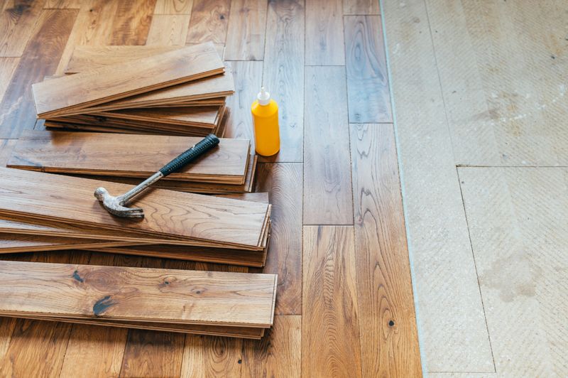 The process of house renovation with changing of the floor from carpets to solid oak wood. Beautiful golden handscraped oiled European oak brushed for added texture and fine definition of wood grain