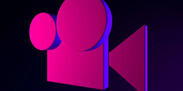 Stylized pink and purple movie camera icon on dark background.