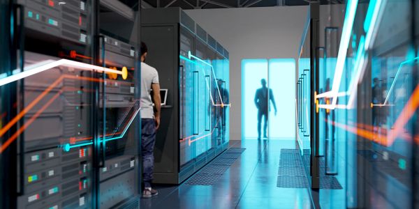 Person working in a futuristic server room with glowing interfaces.