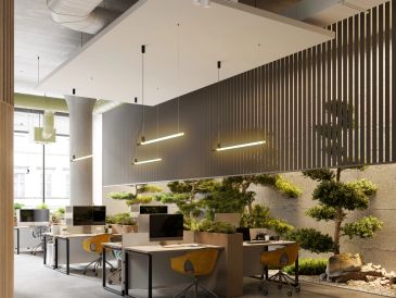 Modern office with green plants and suspended lighting.