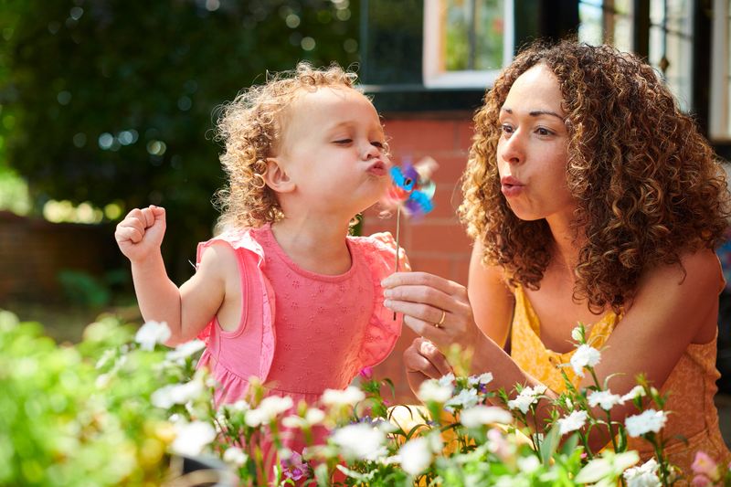 mother and daughter with toy windmill