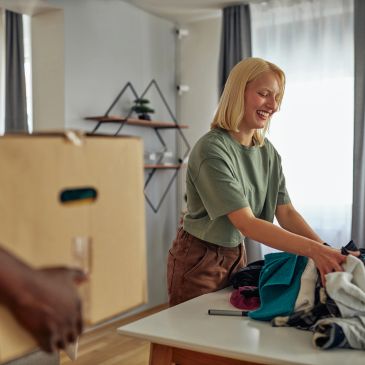 Adult sorting clothes for the Cola Kids Consignment Grown Ups sale