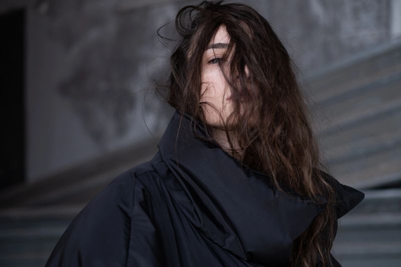 Beautiful young woman wearing black down jacket.