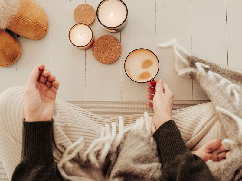 Woman indoors meditating drinking coffee and getting some mindfulness timePhoto taken indoors from above natural light