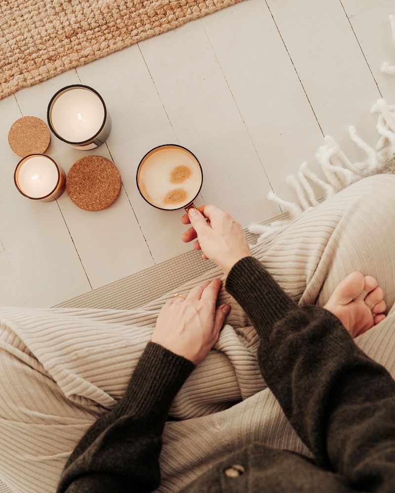 Woman indoors meditating drinking coffee and getting some mindfulness time
Photo taken indoors from above natural light