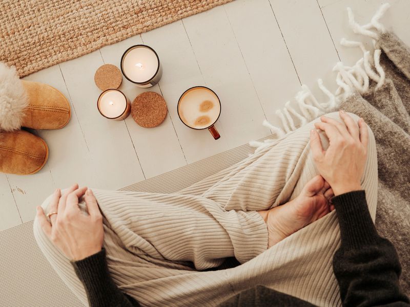 Woman indoors meditating drinking coffee and getting some mindfulness timePhoto taken indoors from above natural light