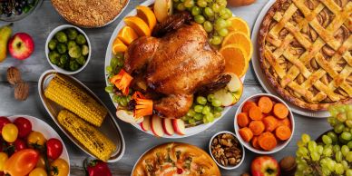 It's time for a festive Thanksgiving dinner spread with roasted turkey, pies, and fresh vegetables |