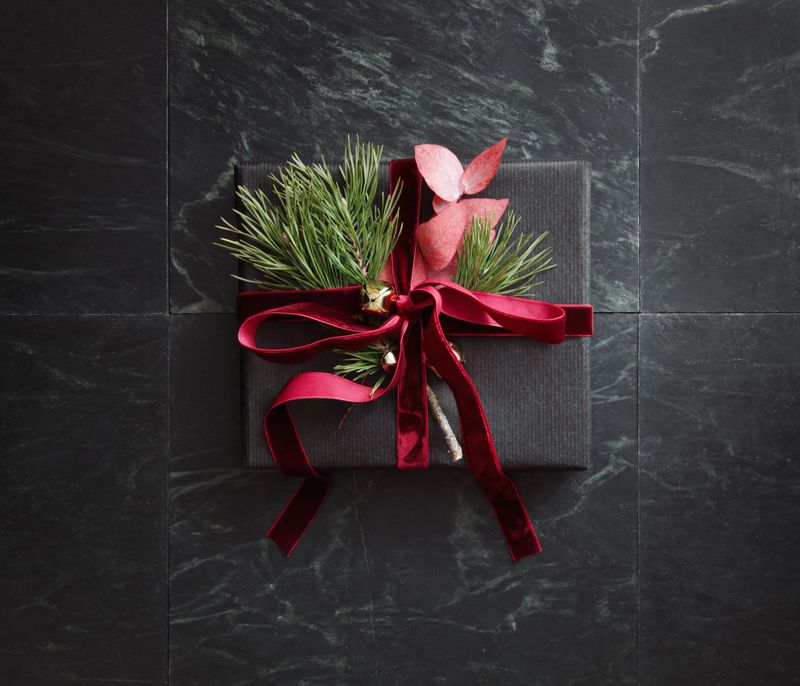 High angle view of Christmas present wrapped in black paper