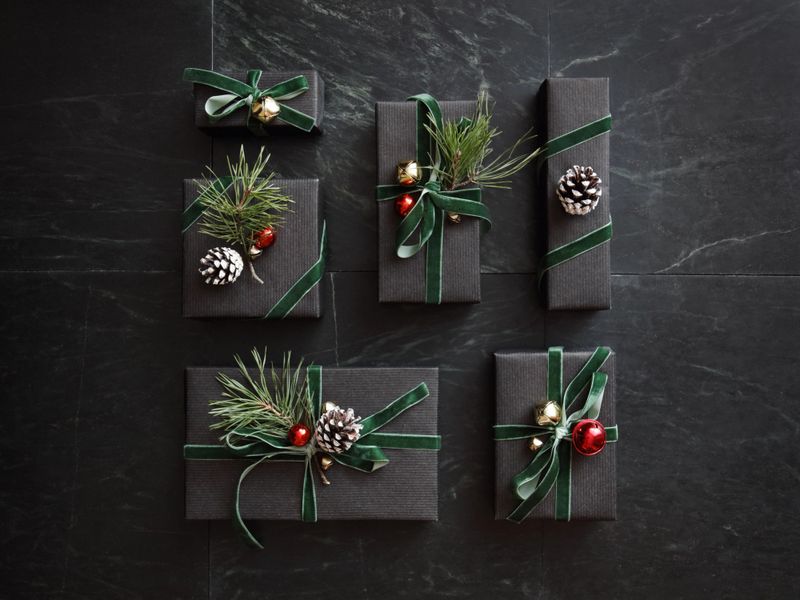 High angle view of Christmas presents wrapped in black paper