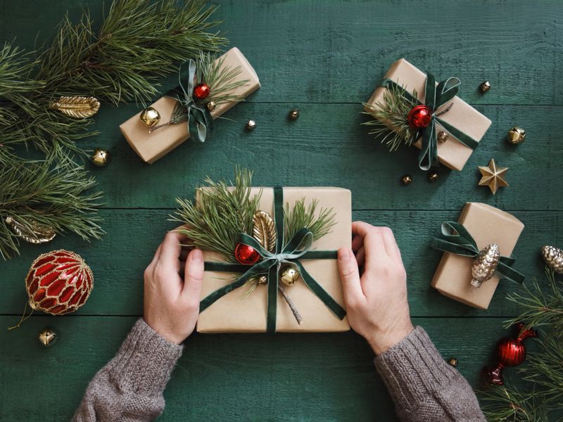 High angle view of male hands and Christmas present