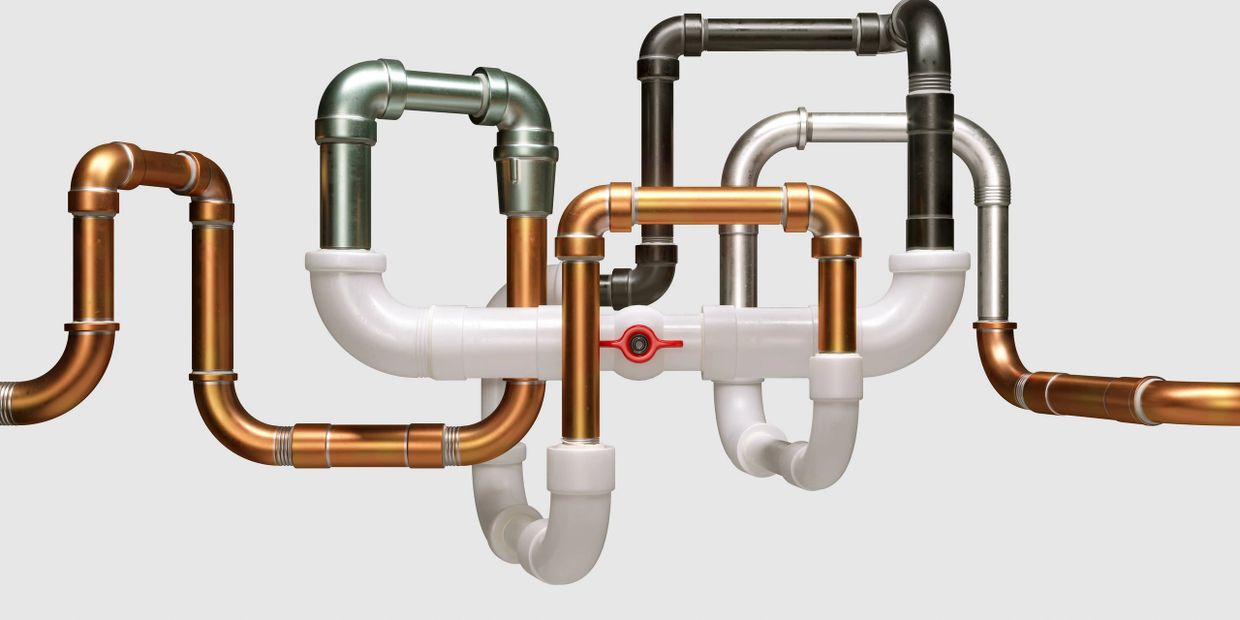 Complex arrangement of multi-colored interconnected pipes against a plain background.