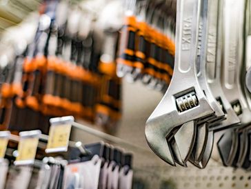 Close-up of adjustable wrenches hanging in a hardware store.