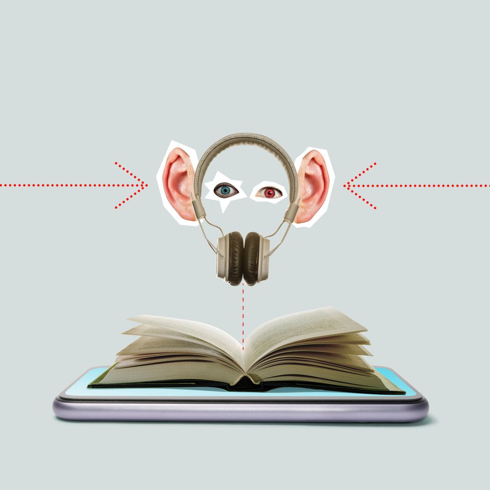 Open book on a phone with ears, eyes, and headphones above it, symbolizing learning and listening.