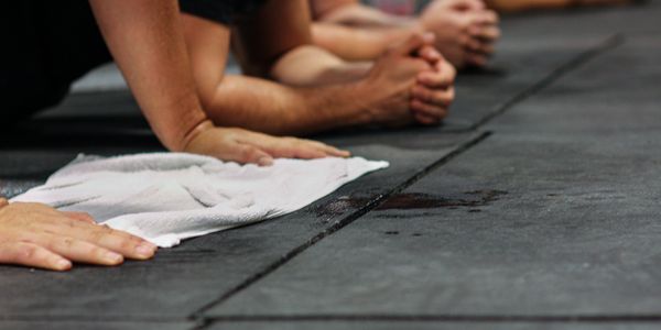 People sweating on floor after exercise