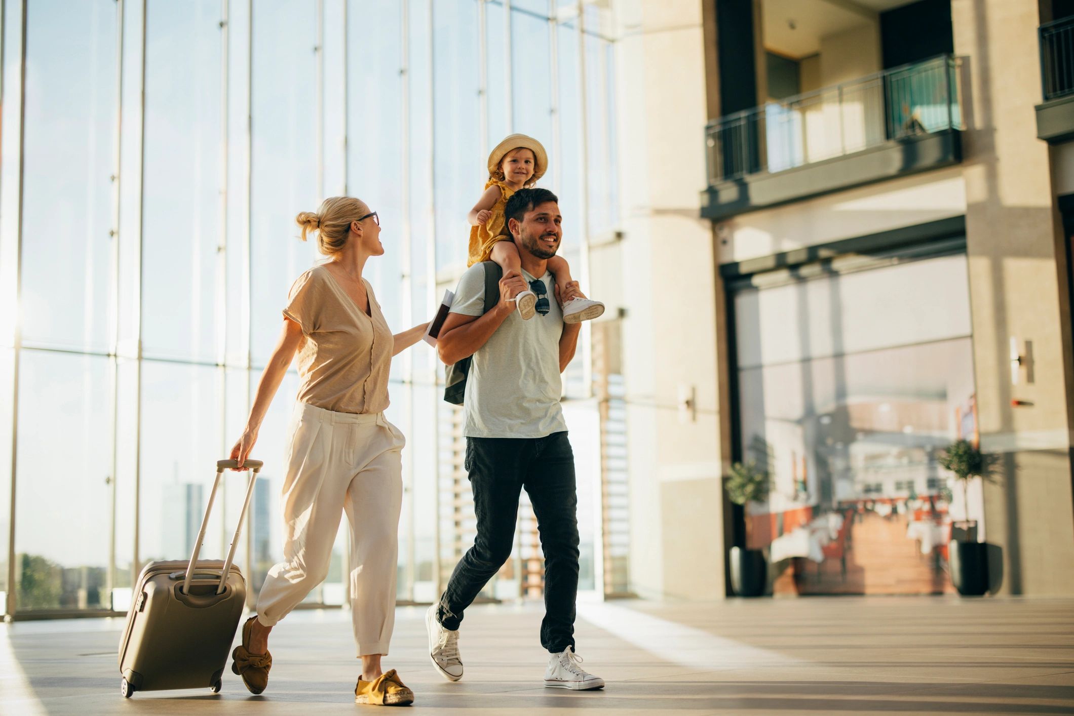 Family traveling happily through a modern airport terminal.