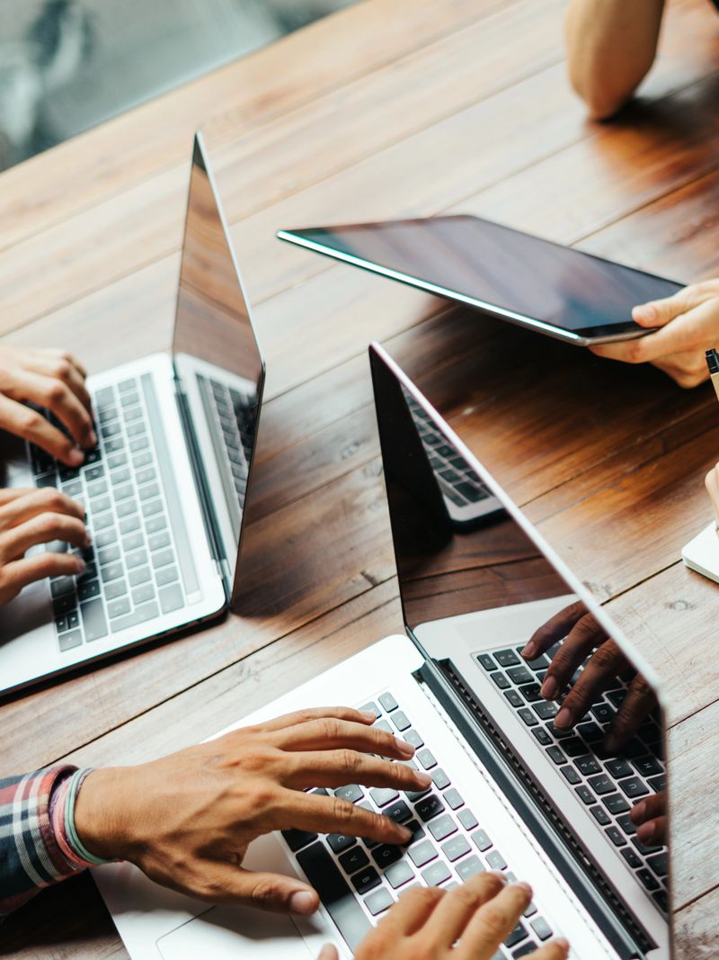 Group of young people working together. Creative business people in modern office. Hipster team in coworking. Young modern colleagues. Teamwork. Startup concept