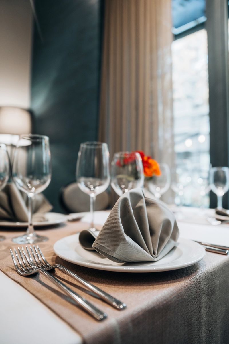 Luxury table setting  with a flower arrangement in a middle.