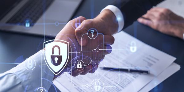 Two people shaking hands over a document with digital security icons overlay.