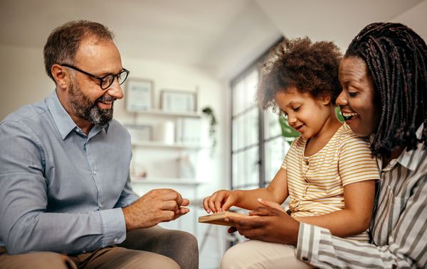 Family enjoying time together playing a game.