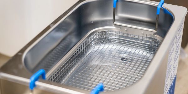 Close-up of an empty ultrasonic cleaner basket.