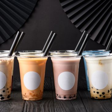 Colorful bubble teas with large straws.
