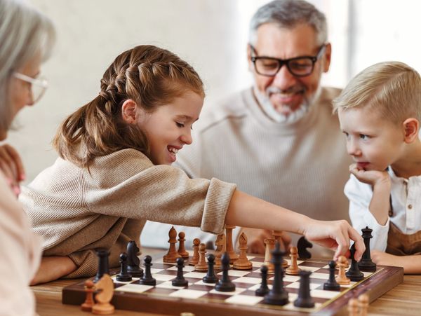 Family enjoying a game of chess together at home.