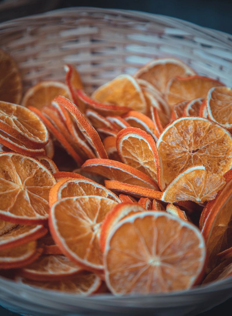 Christmas tree or  decorations, dried fruit garlands of citrus fruit, dried whole oranges, dried tomatoes, lime slices, cinnamon sticks and pine cones, green spruce needles