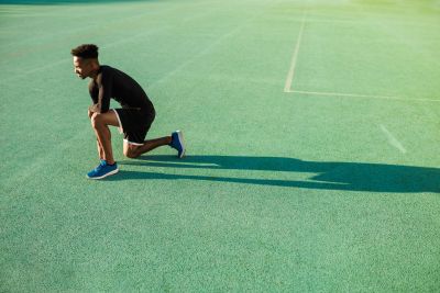 Athlete getting ready to sprint on a track field.