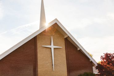 Church building with a prominent cross.