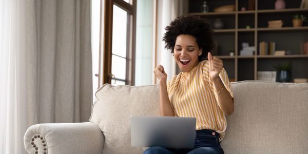 happy woman receives email with house valuation.
