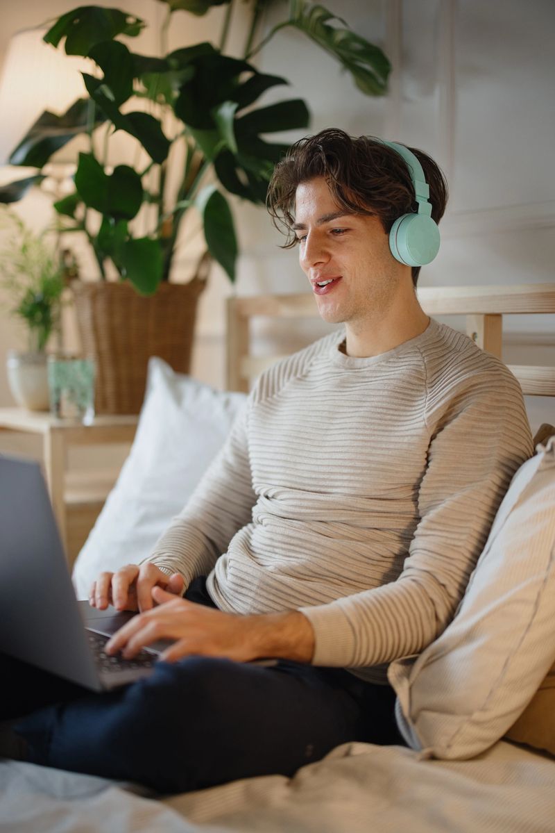 Man working from home using laptop for video call.