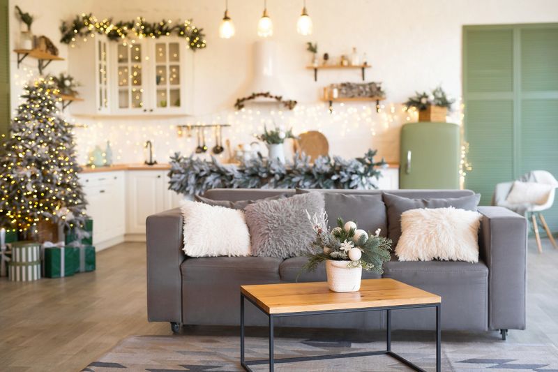 Modern Kitchen Interior with Island, Sink, Cabinets in New Luxury Home Decorated in Christmas Style.