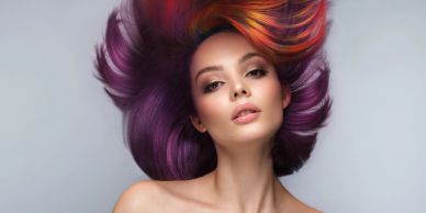 Woman with vibrant colored hair flipping her hair up.