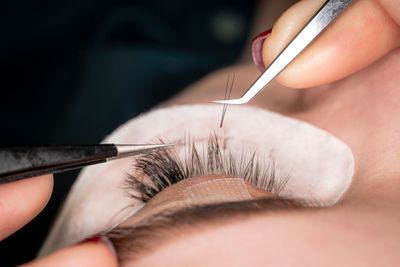 Applying eyelash extensions for a natural, flawless look.