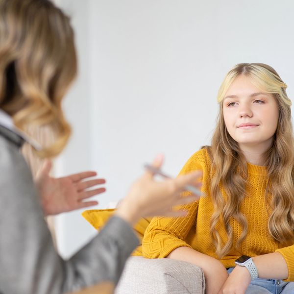 Teen girl listens attentively during a counseling session.