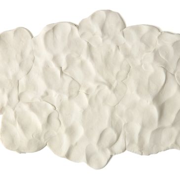Close-up of soft, uneven white clay texture.