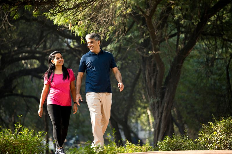 Happy couple walking at park