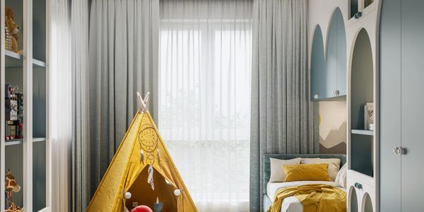 Cozy children's bedroom with a yellow teepee and soft bedding in muted tones.