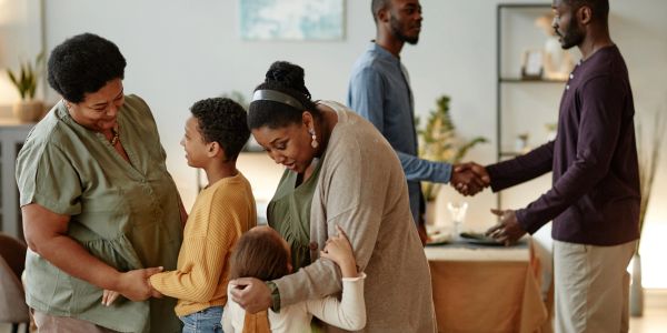 Family members greeting warmly inside a cozy home.