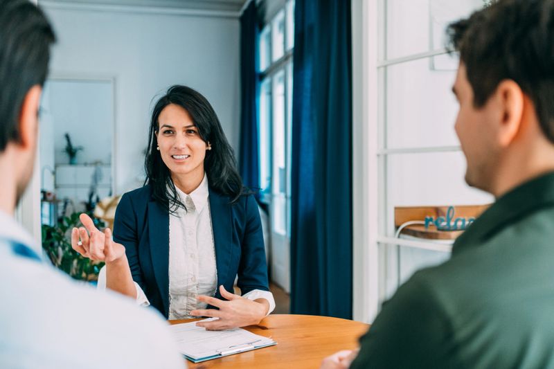 Shot of group of business persons in business meeting. Three entrepreneurs on meeting in board room. Corporate business team on meeting in modern office. Female manager discussing new project with her colleagues. Company owner on a meeting with two of her employees in her office.