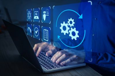 Stock image of a person using a laptop running an application infused with AI/ML capabilities.