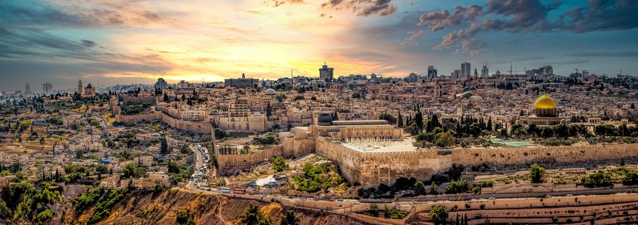 Panoramic view of Jerusalem at sunset with the Dome of the Rock.