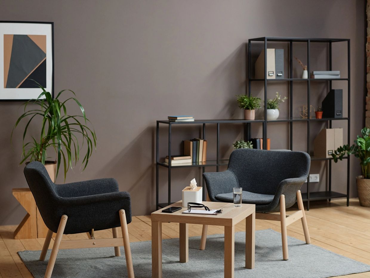 Modern living room with gray chairs and wooden furniture.