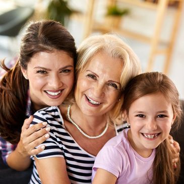 Three generations of happy women smiling together.