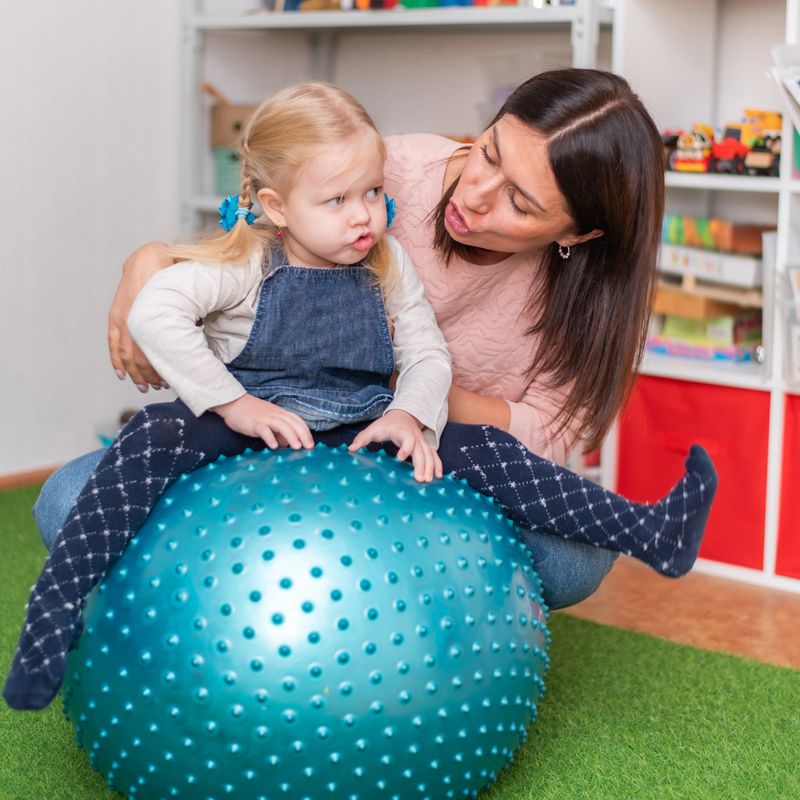 Woman speech therapist helps girls correct her speech