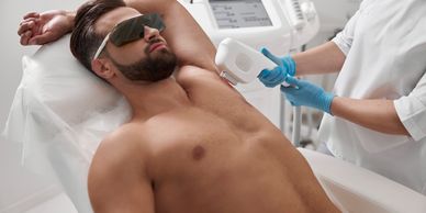 Man undergoing laser hair removal treatment on his armpit.
