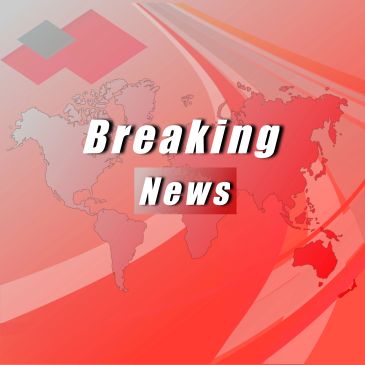 Breaking news graphic with world map background.