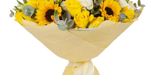 Bright bouquet with sunflowers, yellow roses, and white flowers wrapped in yellow paper.